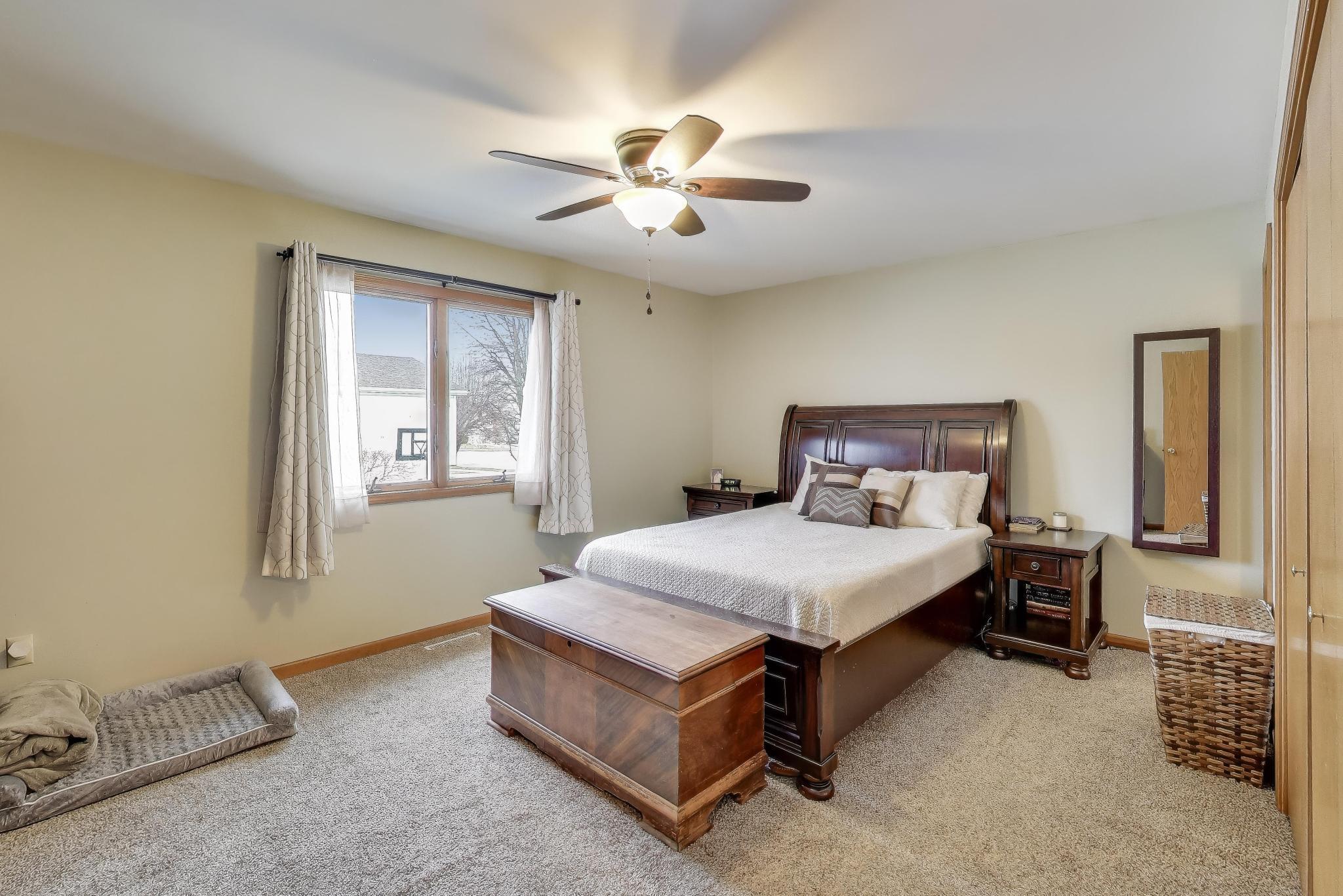 6926 Hawk Drive Schererville, IN 46375 - Photo 17 of 44 a bedroom with a bed and a window