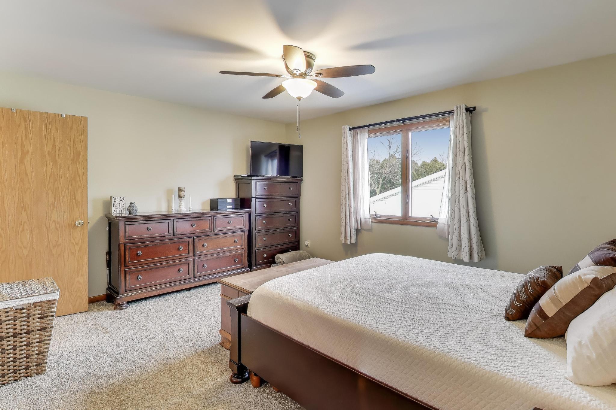 6926 Hawk Drive Schererville, IN 46375 - Photo 19 of 44 a bedroom with a bed and a dresser