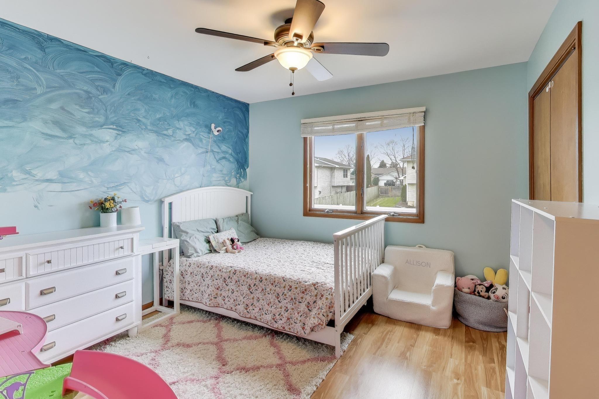 6926 Hawk Drive Schererville, IN 46375 - Photo 21 of 44 a bedroom with a bed and wooden floor