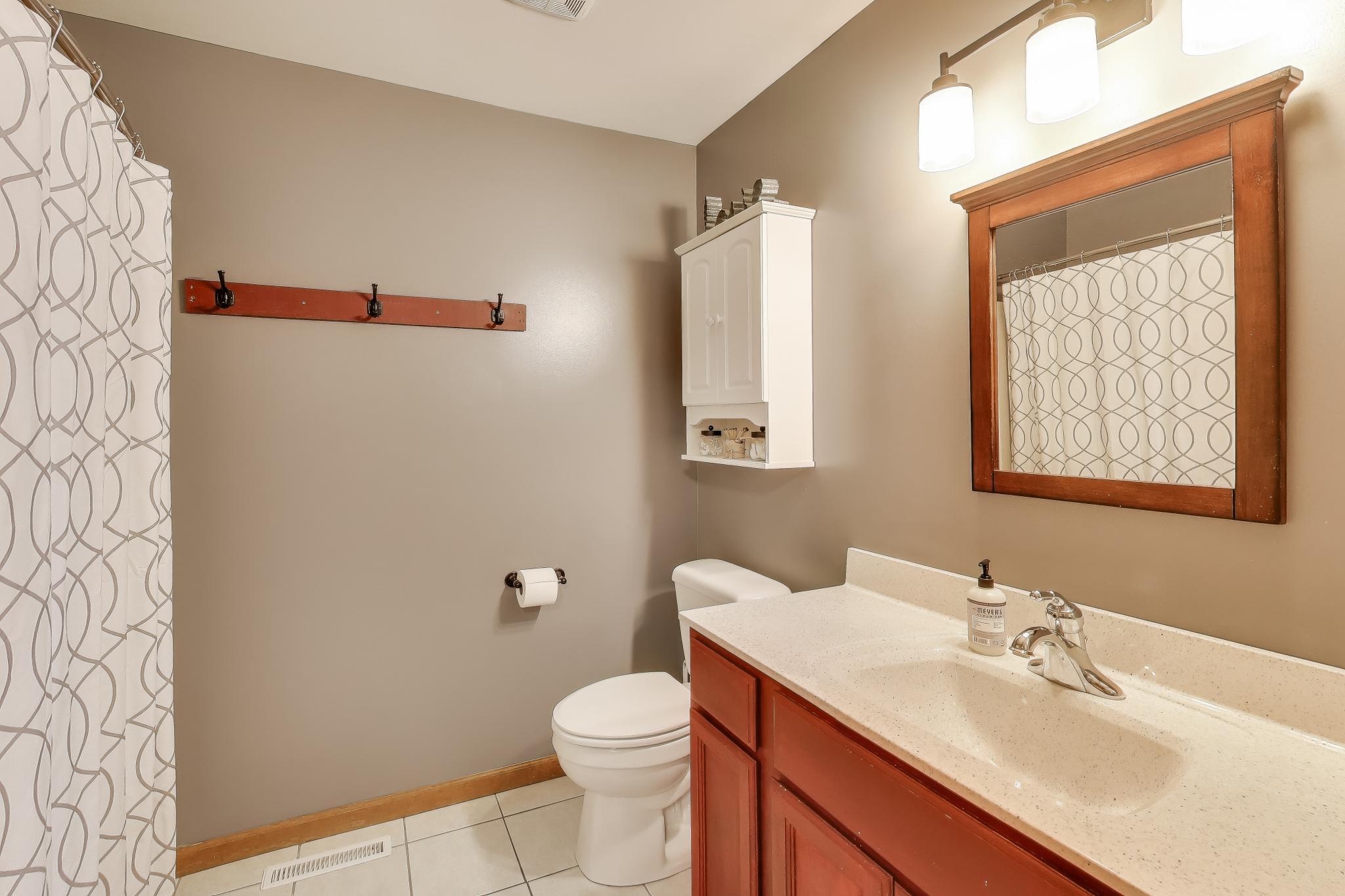 6926 Hawk Drive Schererville, IN 46375 - Photo 25 of 44 a bathroom with a sink vanity mirror and toilet