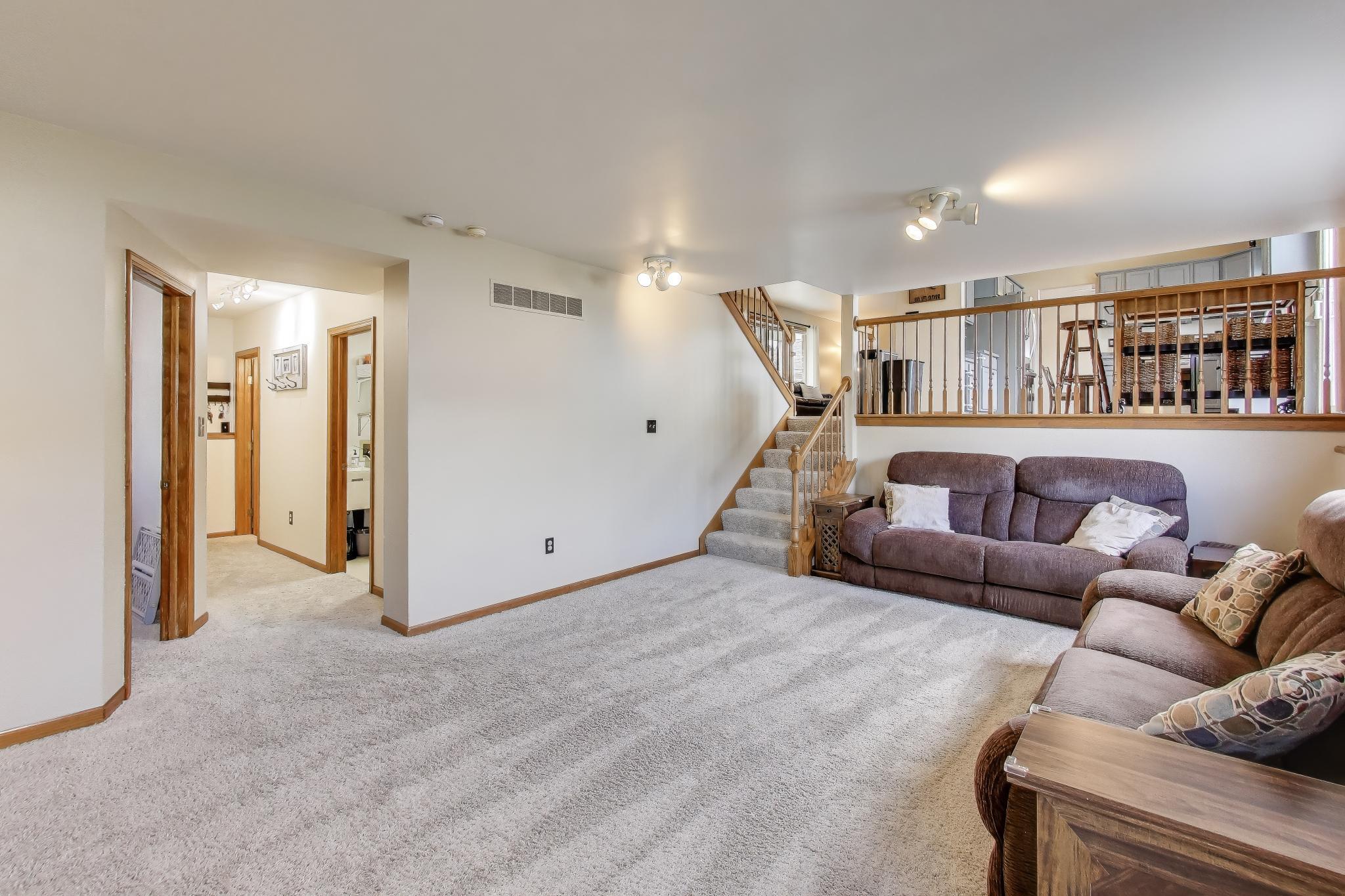 6926 Hawk Drive Schererville, IN 46375 - Photo 27 of 44 a living room with furniture and a book shelf