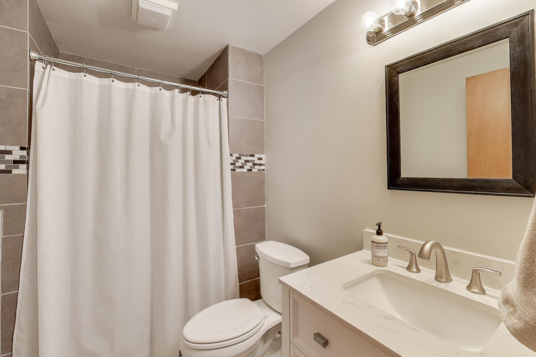 6926 Hawk Drive Schererville, IN 46375 - Photo 31 of 44 a bathroom with a toilet a sink and a mirror