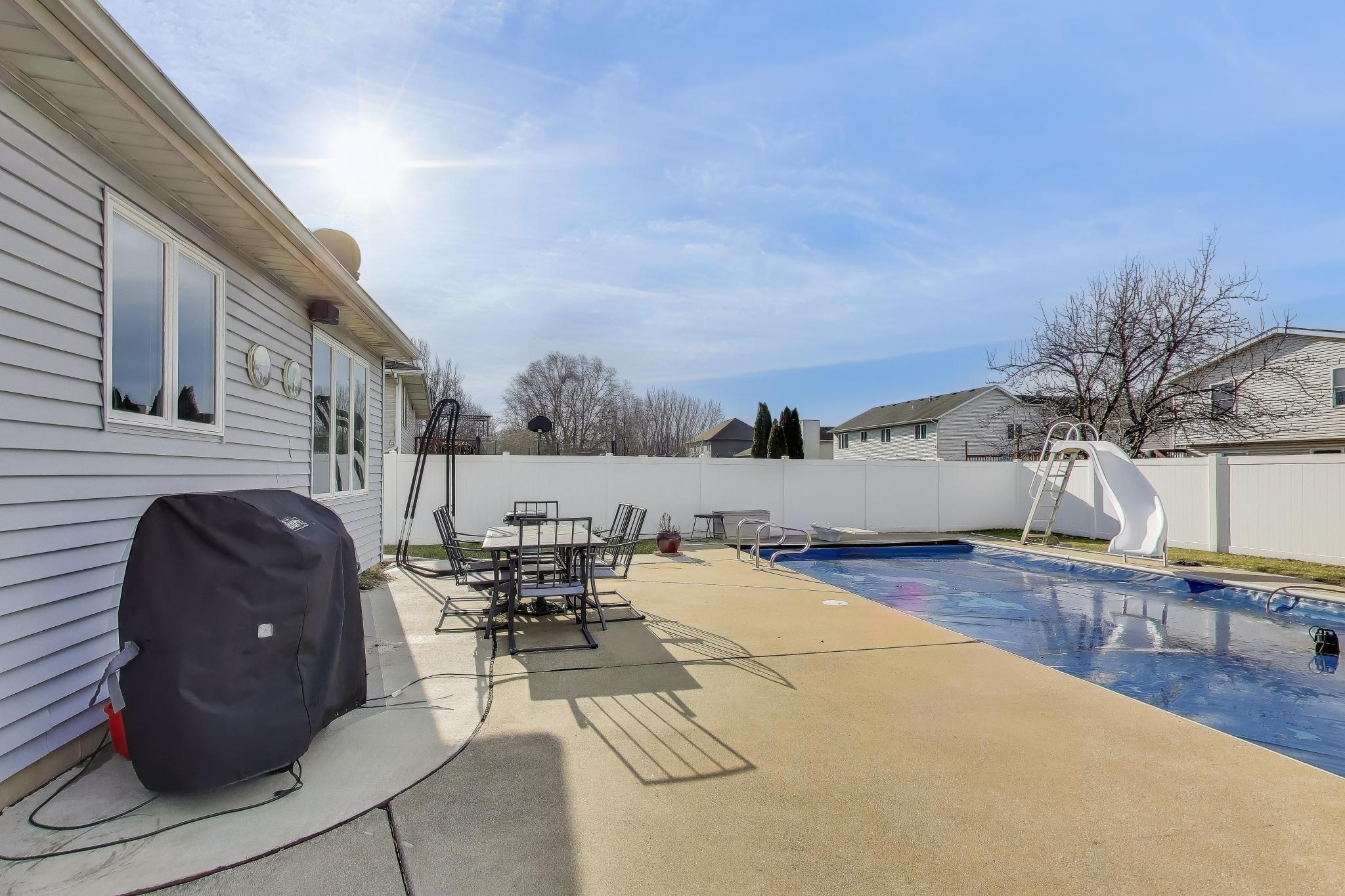 6926 Hawk Drive Schererville, IN 46375 - Photo 36 of 44 a living room with furniture a flat screen tv and a table