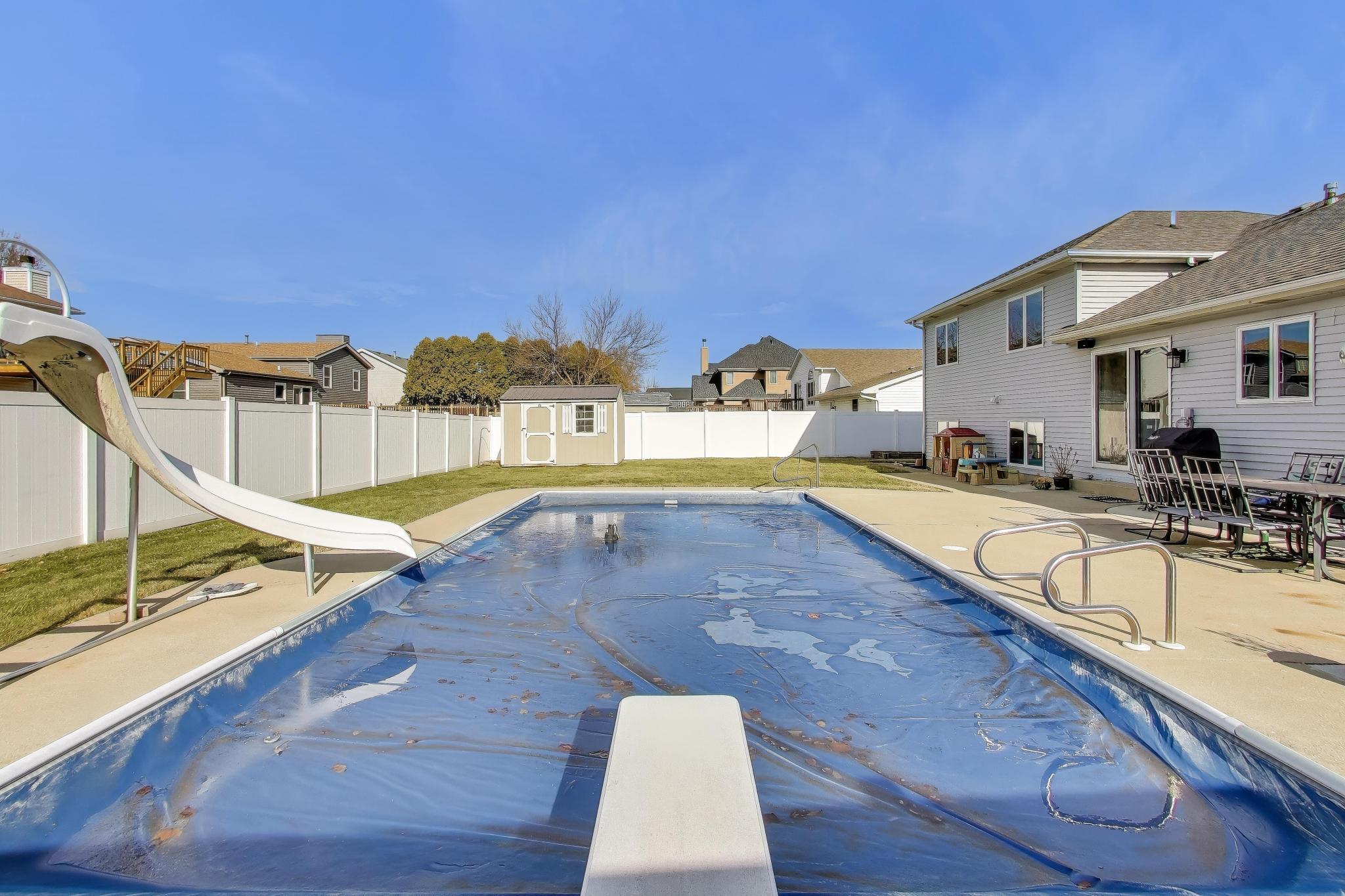 6926 Hawk Drive Schererville, IN 46375 - Photo 40 of 44 a view of a swimming pool with a lounge chairs