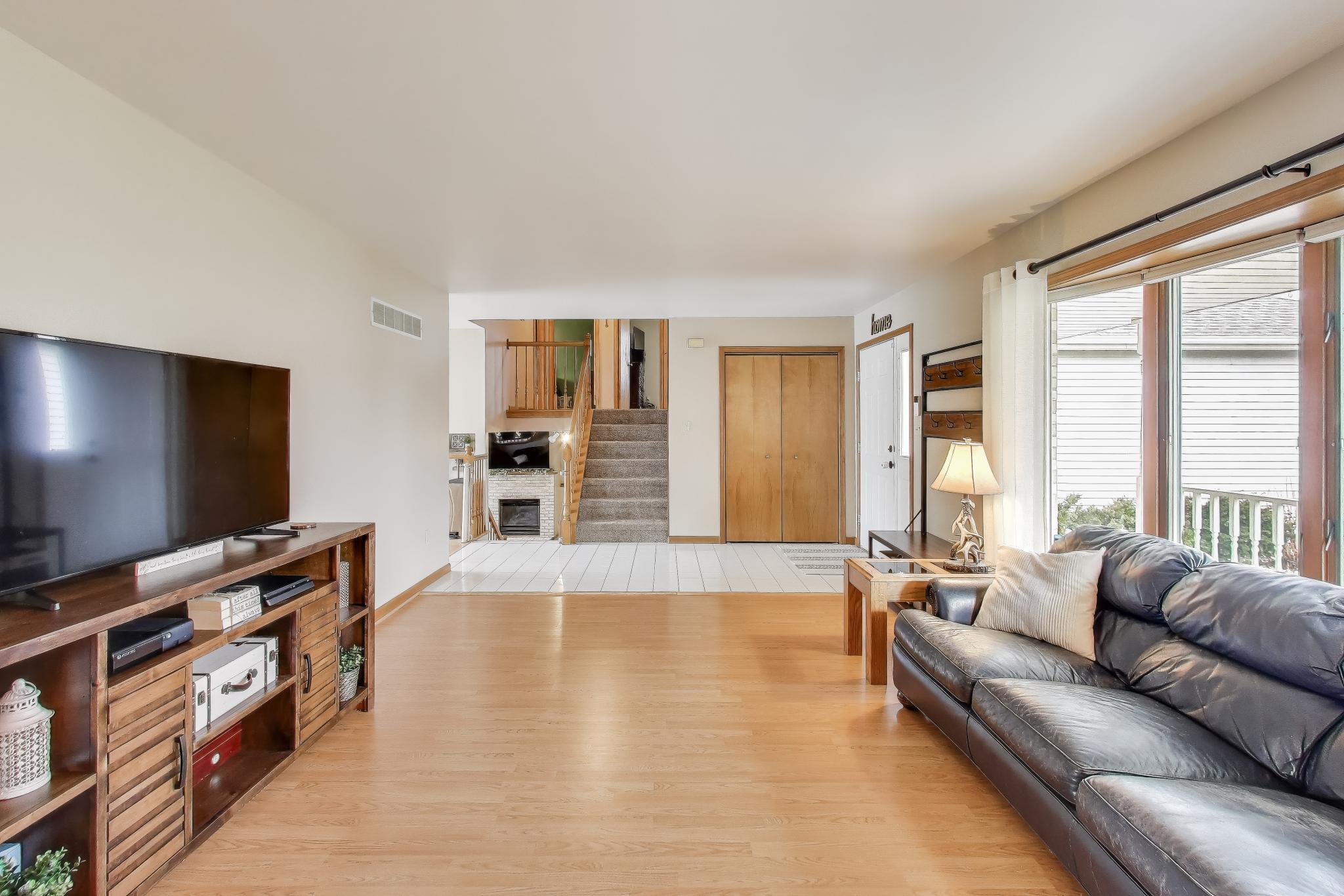 6926 Hawk Drive Schererville, IN 46375 - Photo 8 of 44 a living room with furniture and a flat screen tv