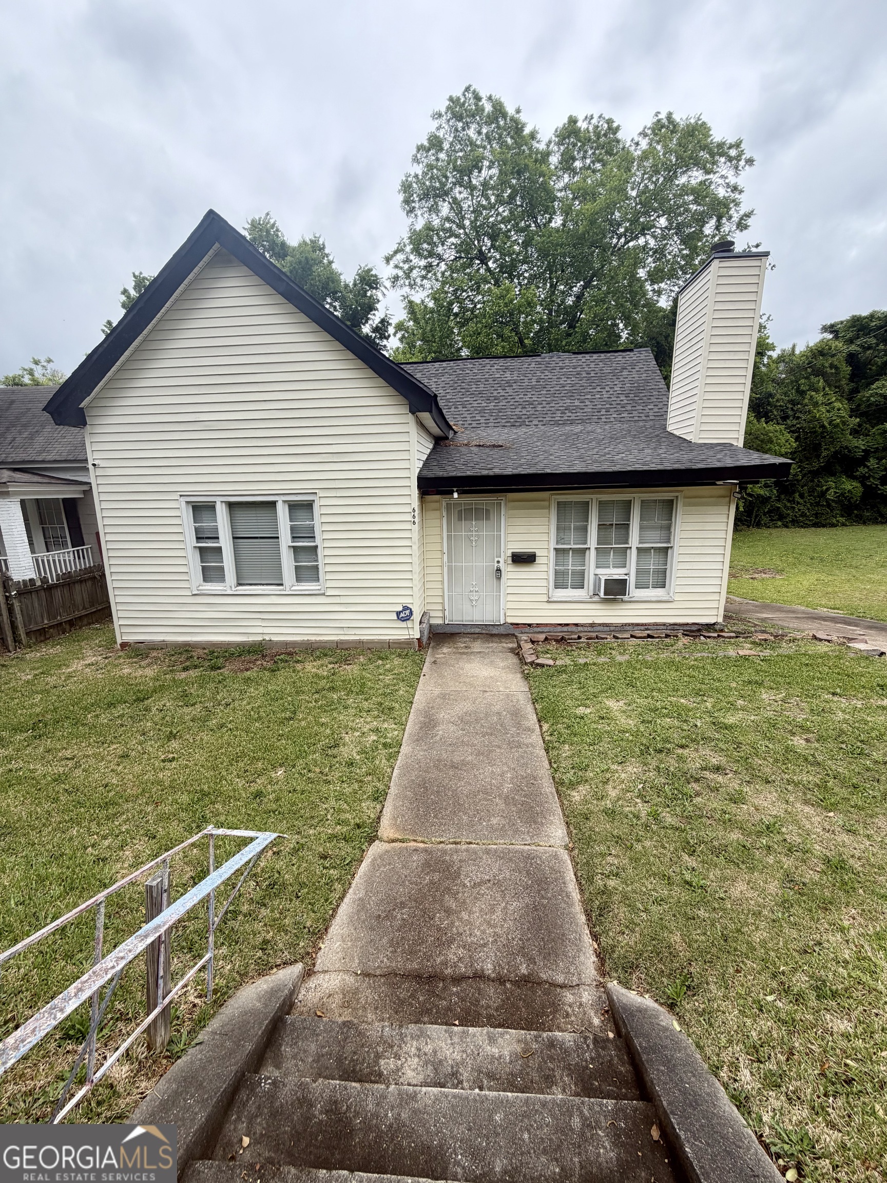 a front view of a house with garden