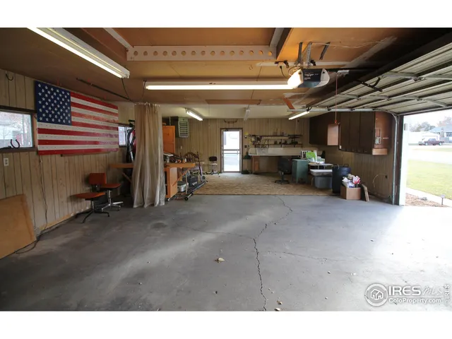 a view of a house with a door and wooden bench