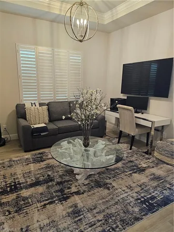 a bedroom with a bed a mirror and a window