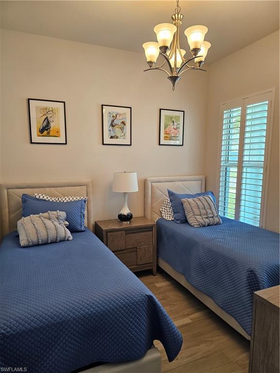 9022 Redonda Drive Naples, FL 34114 - Photo 12 of 28 a bedroom with a bed chandelier and couch
