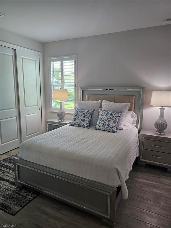 9022 Redonda Drive Naples, FL 34114 - Photo 13 of 28 a bedroom with a bed a mirror and a window