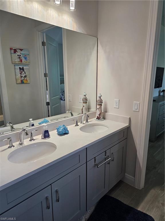 9022 Redonda Drive Naples, FL 34114 - Photo 14 of 28 a bathroom with double vanity sinks and a mirror