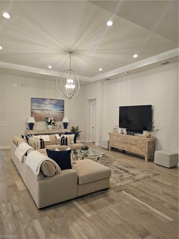 9022 Redonda Drive Naples, FL 34114 - Photo 5 of 28 a living room with furniture and a flat screen tv