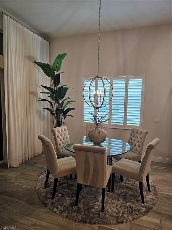 9022 Redonda Drive Naples, FL 34114 - Photo 6 of 28 a view of a dining room with furniture window and wooden floor