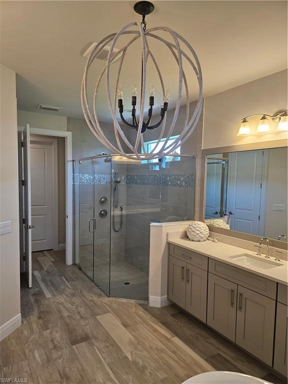 9022 Redonda Drive Naples, FL 34114 - Photo 8 of 28 a bathroom with a sink a mirror and a shower