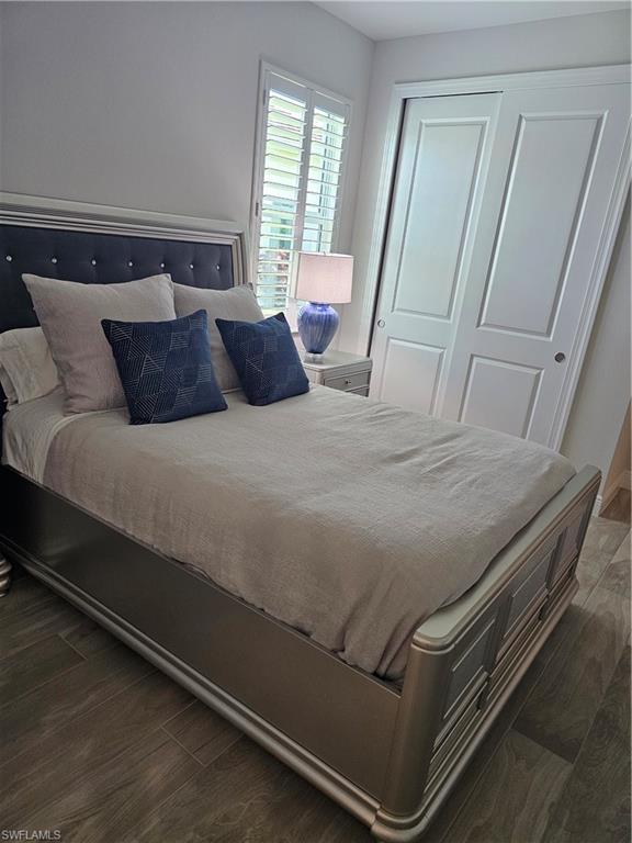 9022 Redonda Drive Naples, FL 34114 - Photo 10 of 28 a bed sitting in a bedroom next to a window