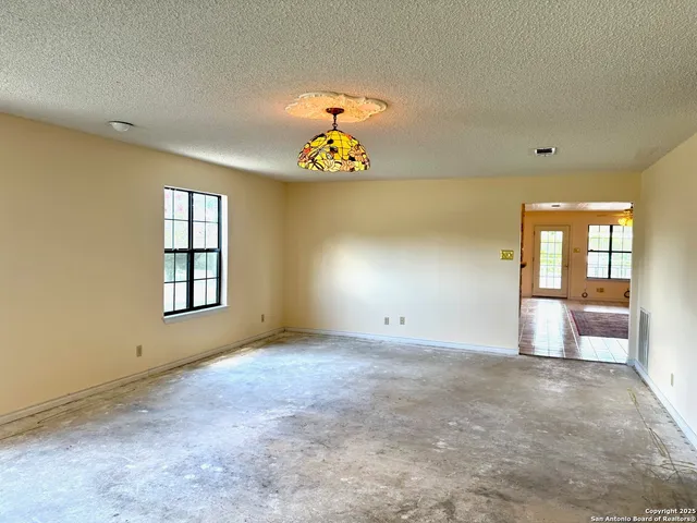 a view of hallway with chandelier and glass door