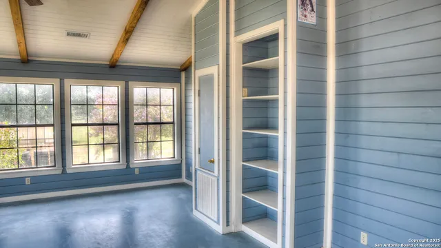 a view of an empty room with a large window
