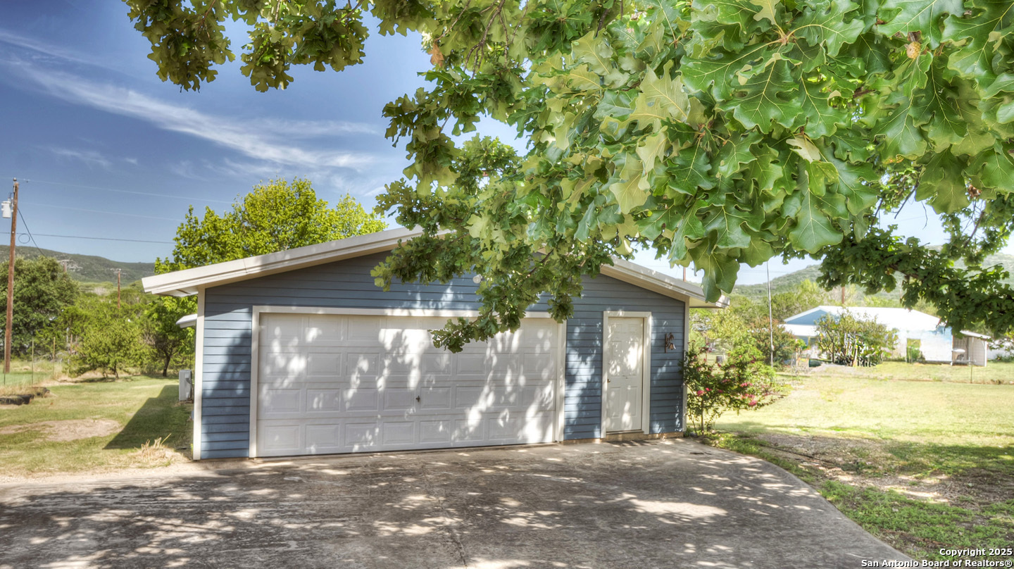 181 Leinweber Drive Leakey, TX 78873 - Photo 33 of 56 a view of a house with a tree in the background