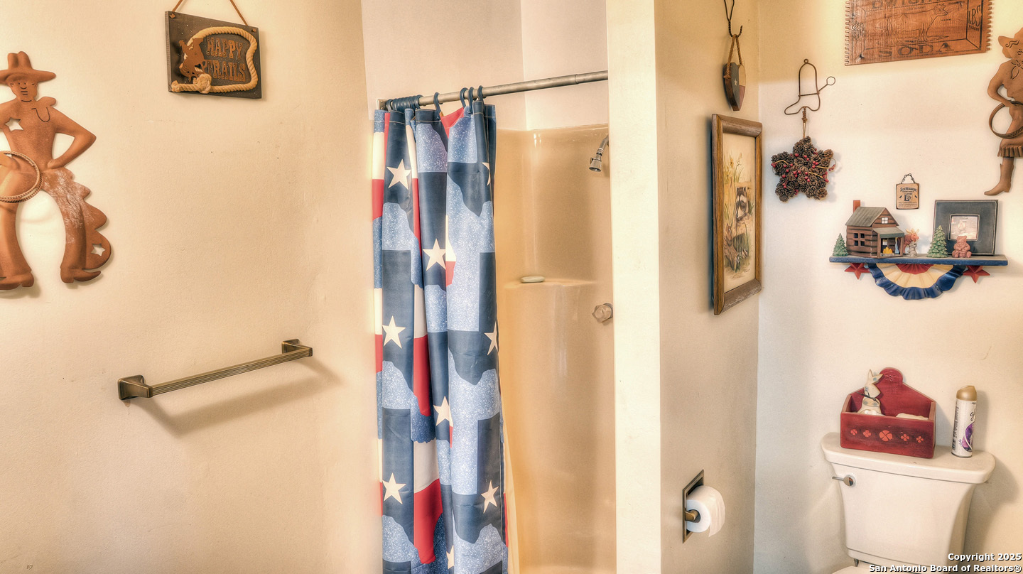 181 Leinweber Drive Leakey, TX 78873 - Photo 39 of 56 a bathroom with a shower and a shower curtain