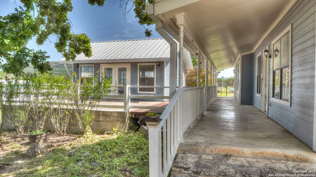 a view of a house with backyard and porch