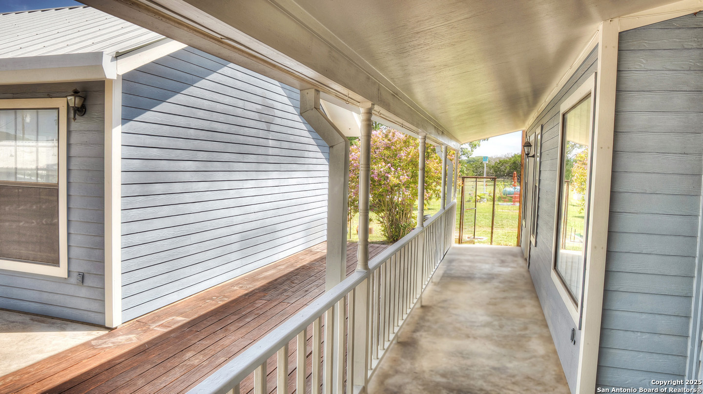 181 Leinweber Drive Leakey, TX 78873 - Photo 9 of 56 a view of a porch with wooden floor and furniture