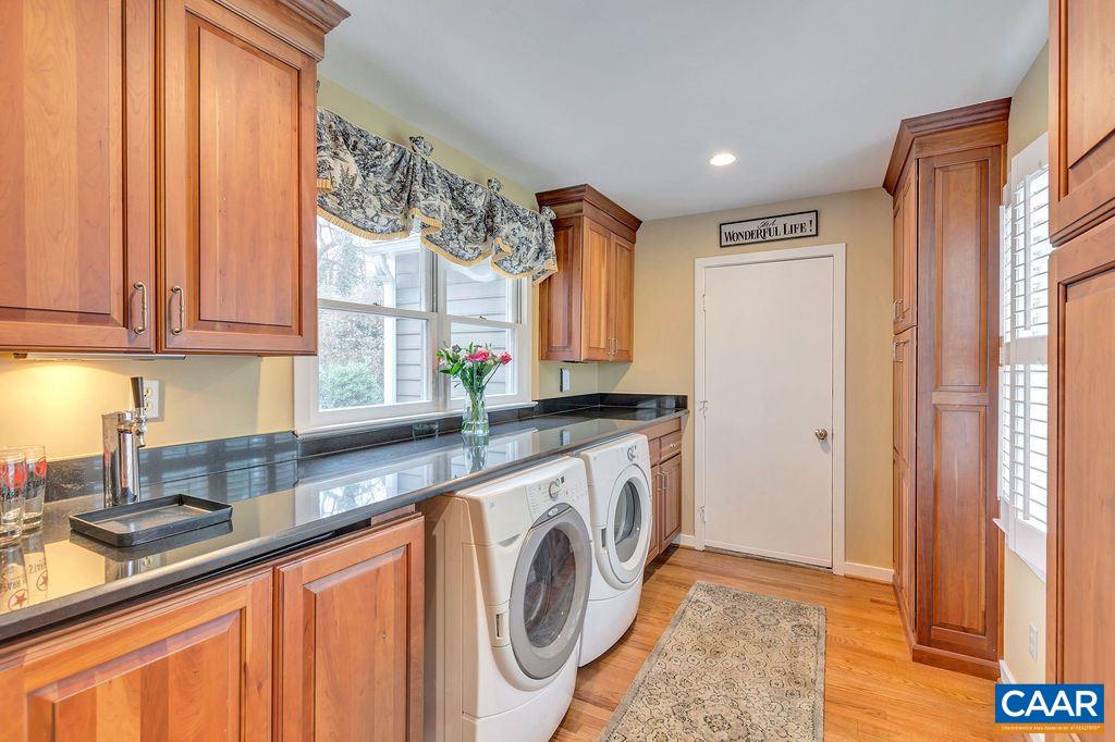 1556 Dairy Road Charlottesville, VA 22903 - Photo 35 of 43 a kitchen with a sink a washer and dryer with wooden floor