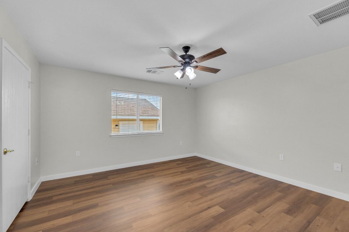11617 Briarcreek Loop Manor, TX 78653 - Photo 16 of 37 Spare room with dark wood finished floors and a ceiling fan