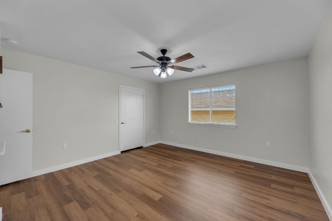 11617 Briarcreek Loop Manor, TX 78653 - Photo 19 of 37 Unfurnished bedroom featuring wood finished floors and a ceiling fan