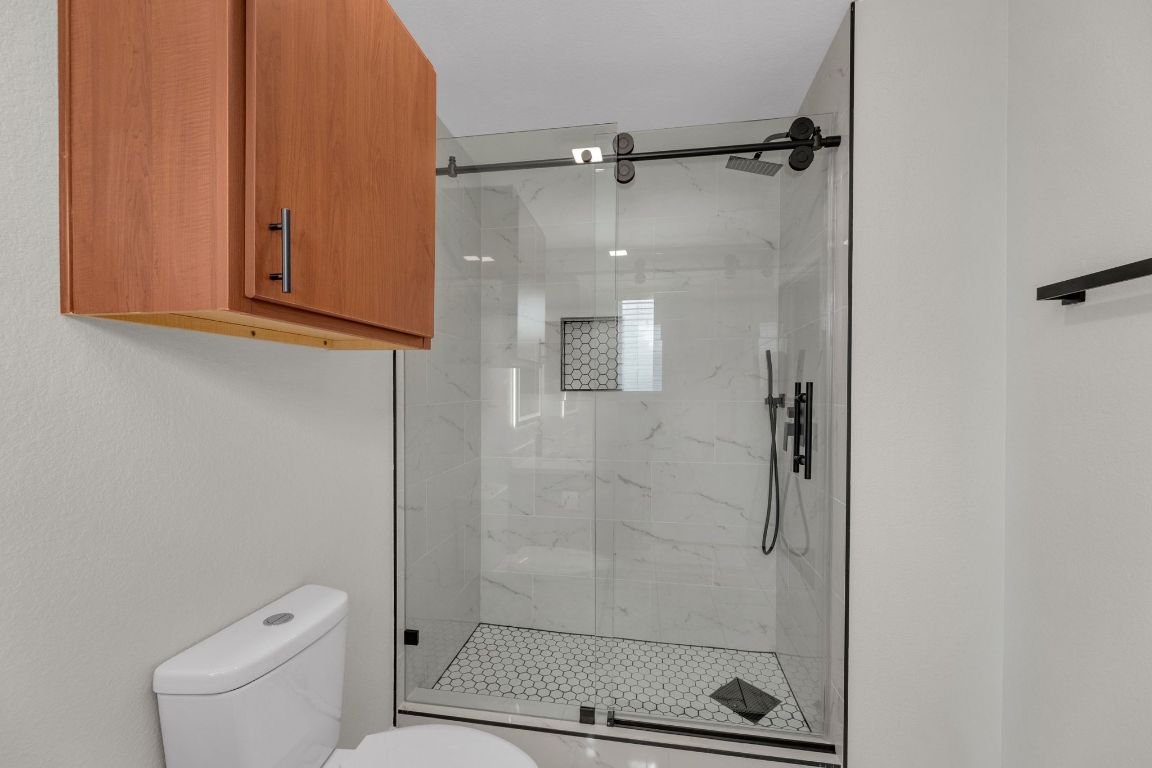 11617 Briarcreek Loop Manor, TX 78653 - Photo 21 of 37 Bathroom featuring a marble finish shower and toilet