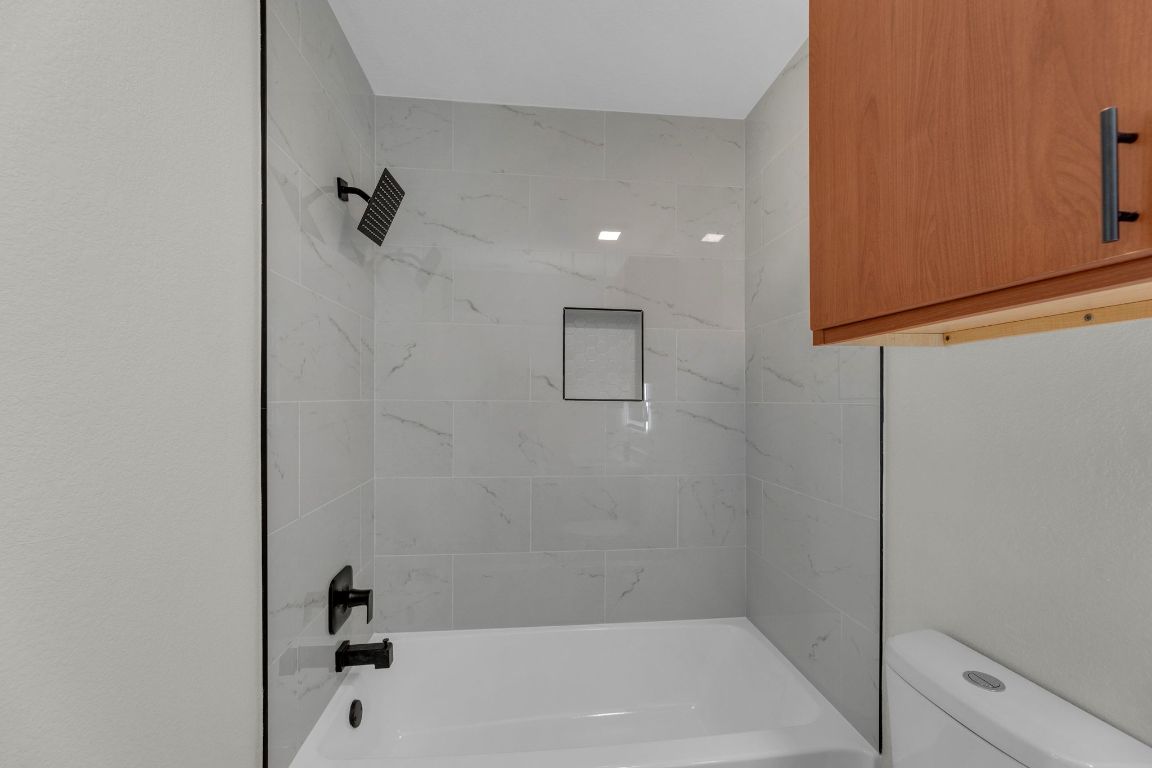11617 Briarcreek Loop Manor, TX 78653 - Photo 23 of 37 Bathroom featuring bathing tub / shower combination and toilet