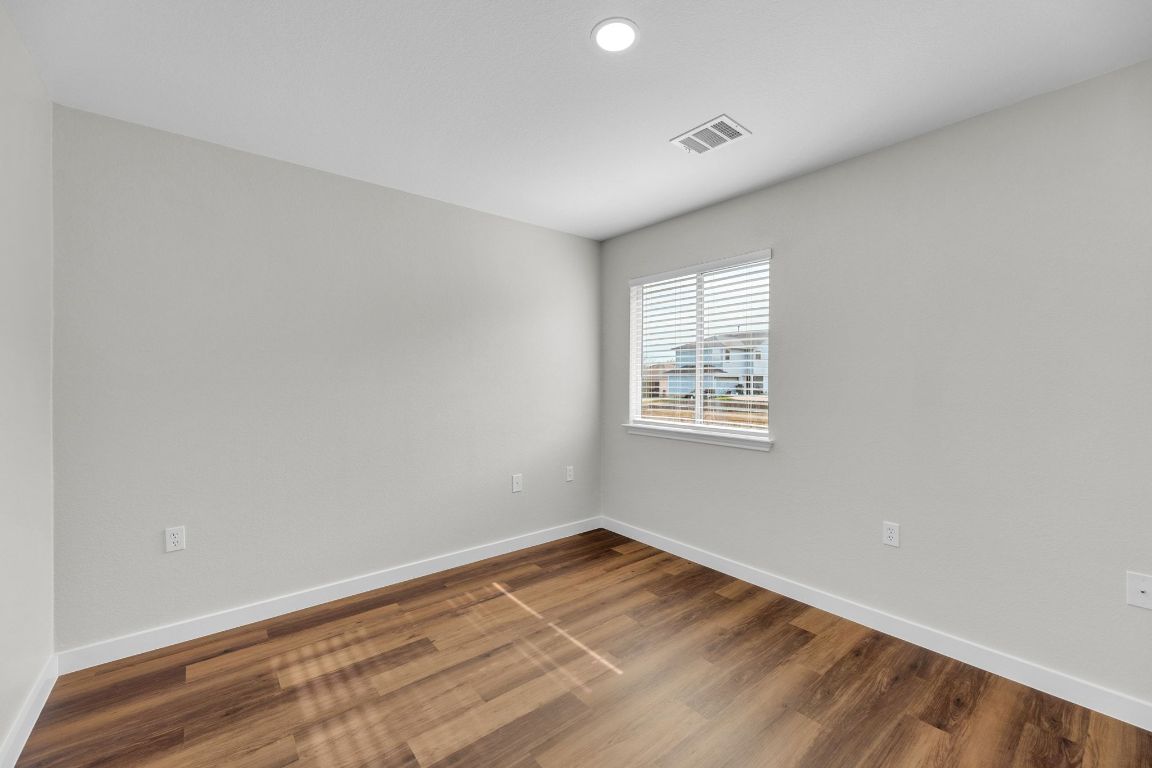11617 Briarcreek Loop Manor, TX 78653 - Photo 24 of 37 Spare room featuring wood finished floors and recessed lighting