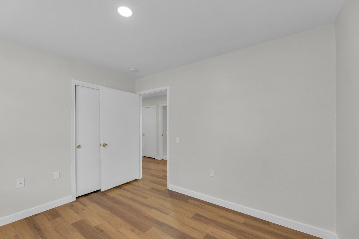 11617 Briarcreek Loop Manor, TX 78653 - Photo 27 of 37 Unfurnished bedroom featuring baseboards and wood finished floors