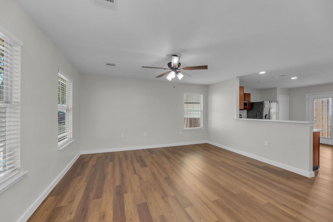 11617 Briarcreek Loop Manor, TX 78653 - Photo 4 of 37 Unfurnished living room featuring dark wood-style flooring, recessed lighting, and a ceiling fan