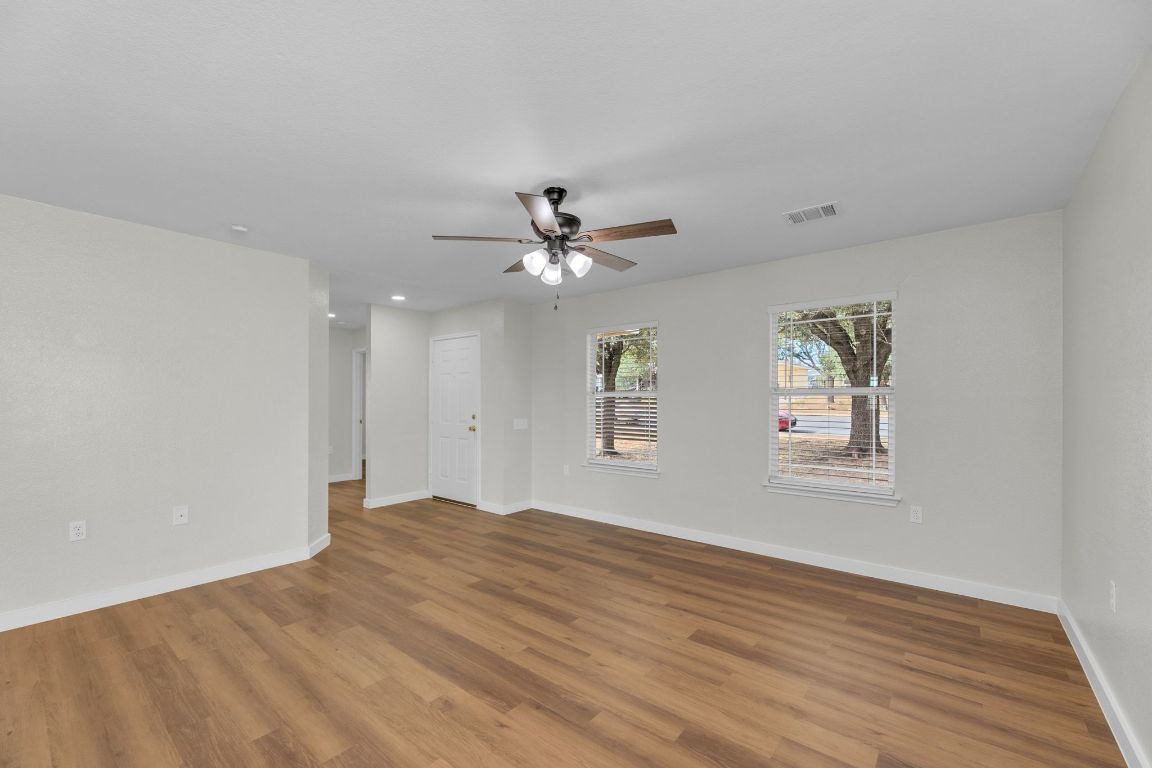 11617 Briarcreek Loop Manor, TX 78653 - Photo 5 of 37 Spare room featuring wood finished floors, ceiling fan, and recessed lighting