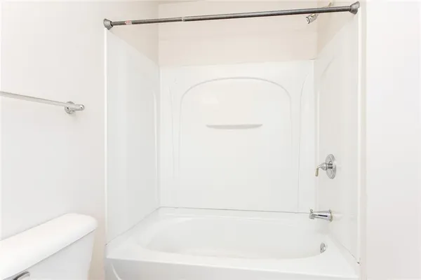 a bathroom with a shower and a toilet