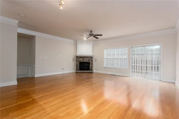 a view of an empty room with a fireplace and a window