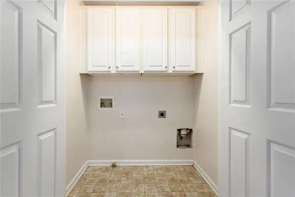 a view of a kitchen with white cabinets