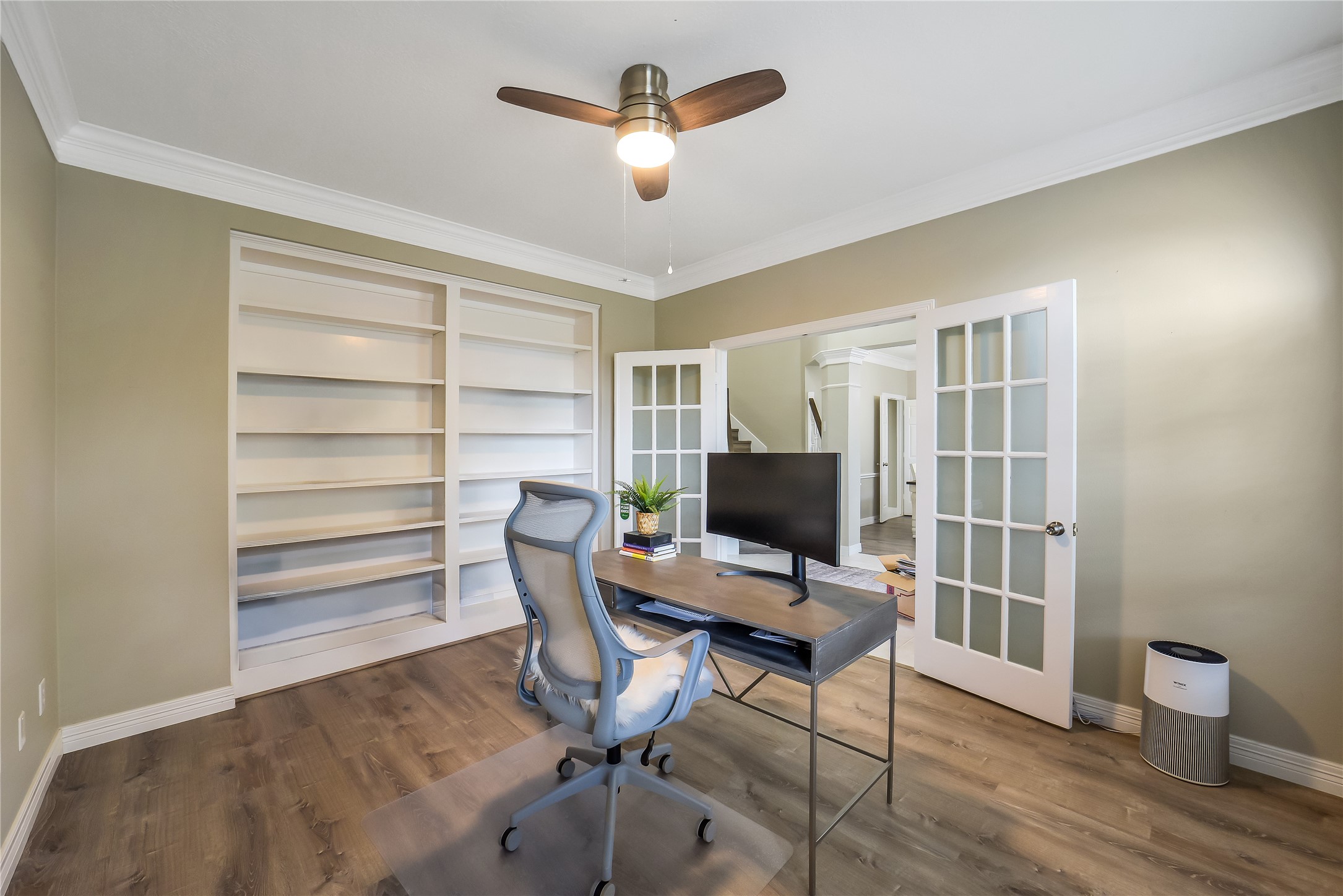 24403 Falcon Point Drive Katy, TX 77494 - Photo 9 of 32 Dedicated home office or study with classic French doors and built-in shelving, offering a quiet and professional workspace.