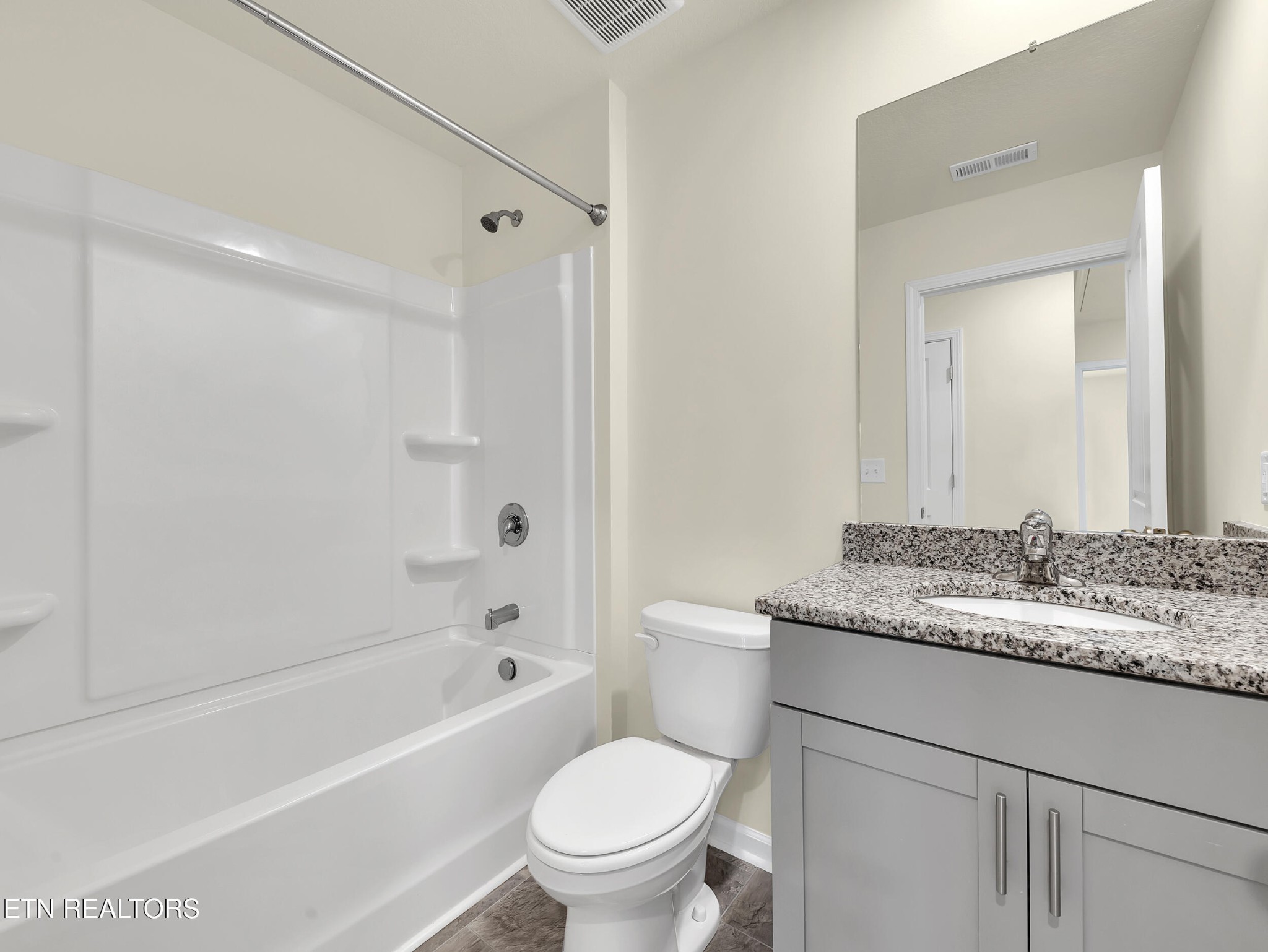 3521 Rylee Jean Way Maryville, TN 37804 - Photo 18 of 20 a bathroom with a granite countertop toilet a sink and a bathtub