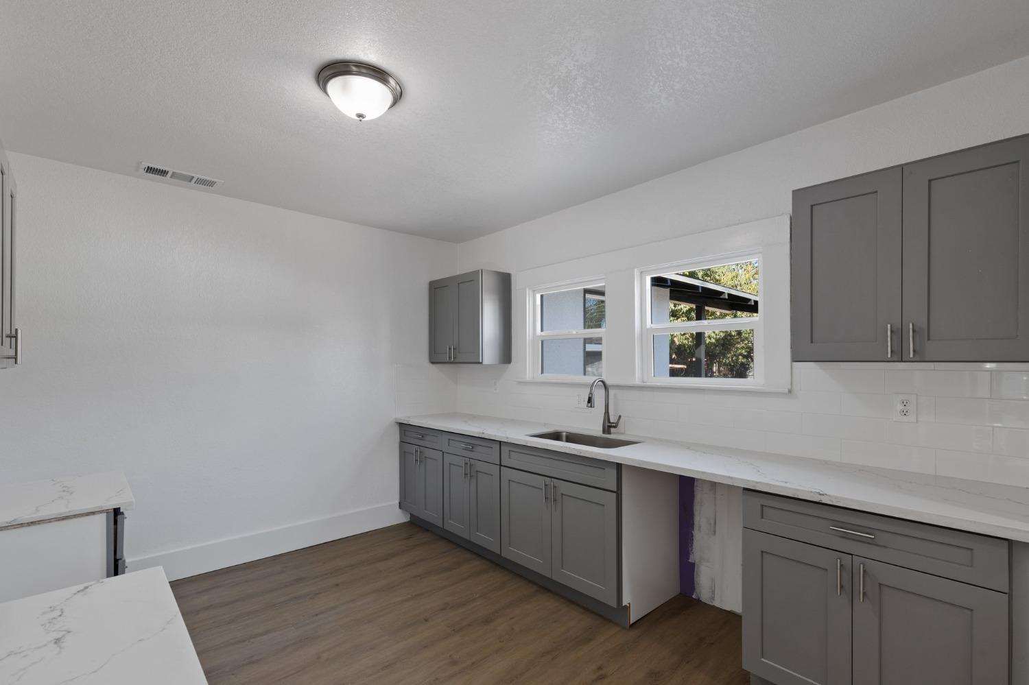 3321 East Montecito Avenue Fresno, CA 93702 - Photo 20 of 22 a kitchen with a sink cabinets and window
