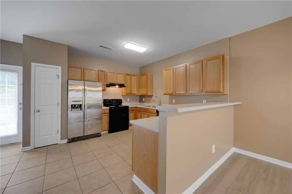 4203 Legacy Square Atlanta, GA 30349 - Photo 15 of 35 a kitchen with a refrigerator sink and cabinets
