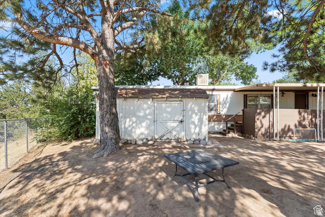 2875 North Hill Field Road, Unit 17 Layton, UT 84041 - Photo 12 of 23 Back of house featuring a storage shed