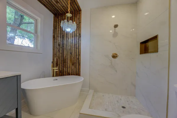 a bathroom with a bathtub and shower