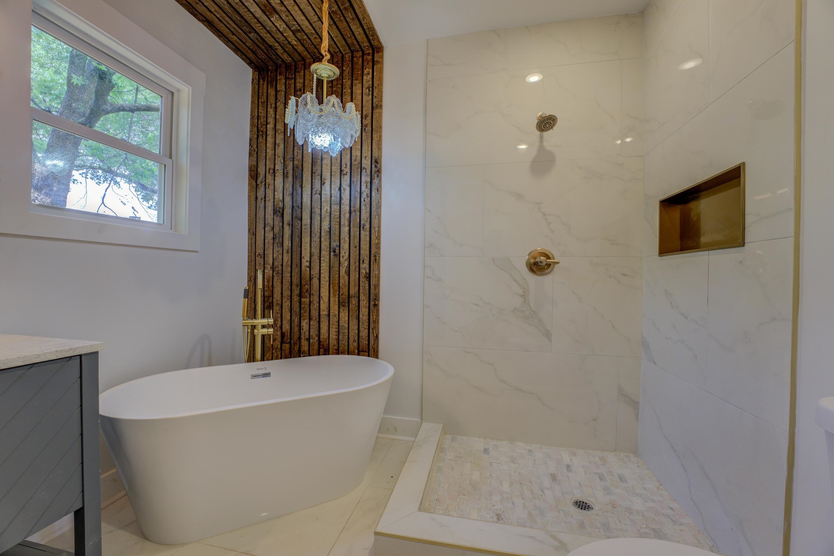 a bathroom with a bathtub and shower