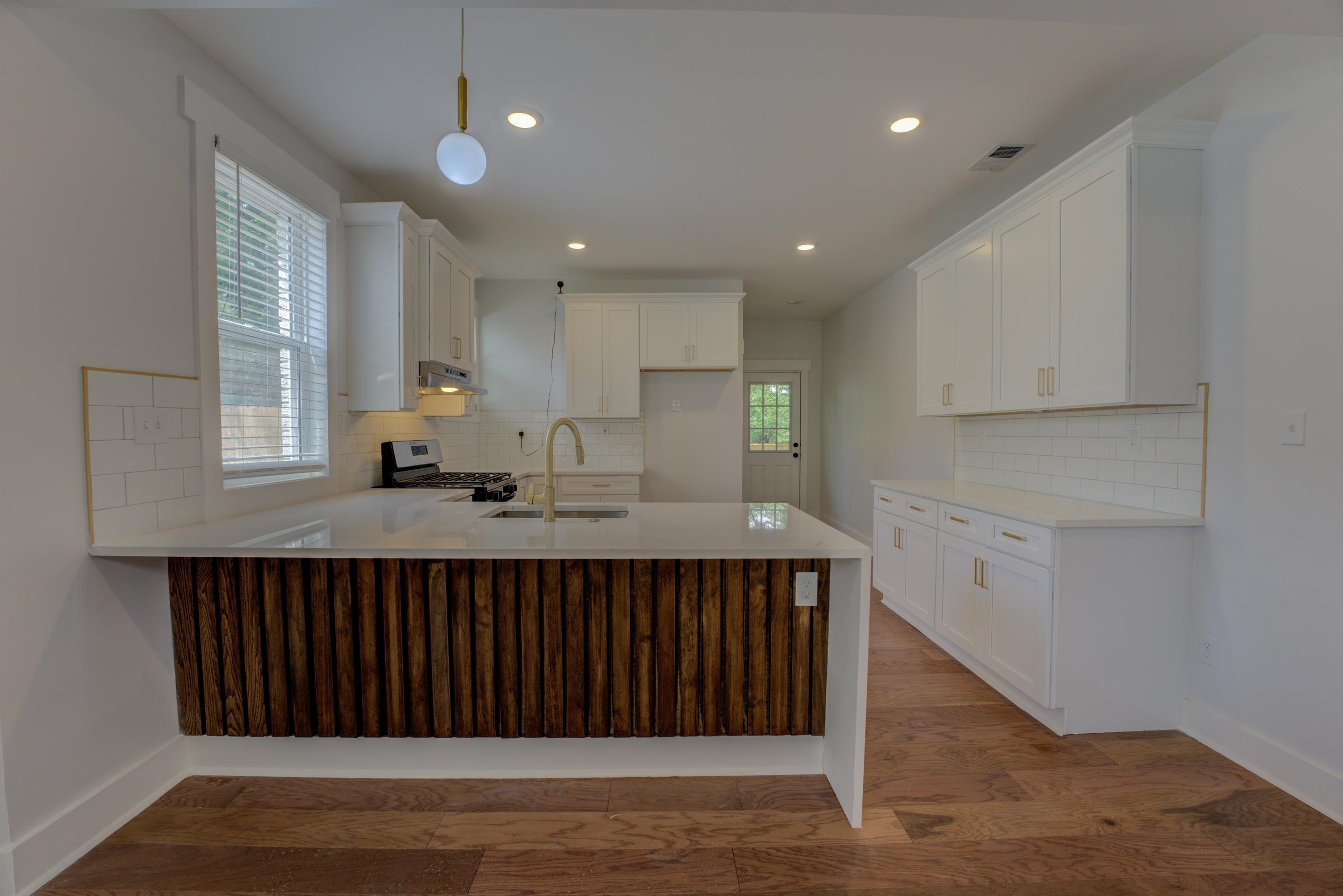 857 E Parkway South Memphis, TN 38104 - Photo 10 of 30 a kitchen with counter top space cabinets and window