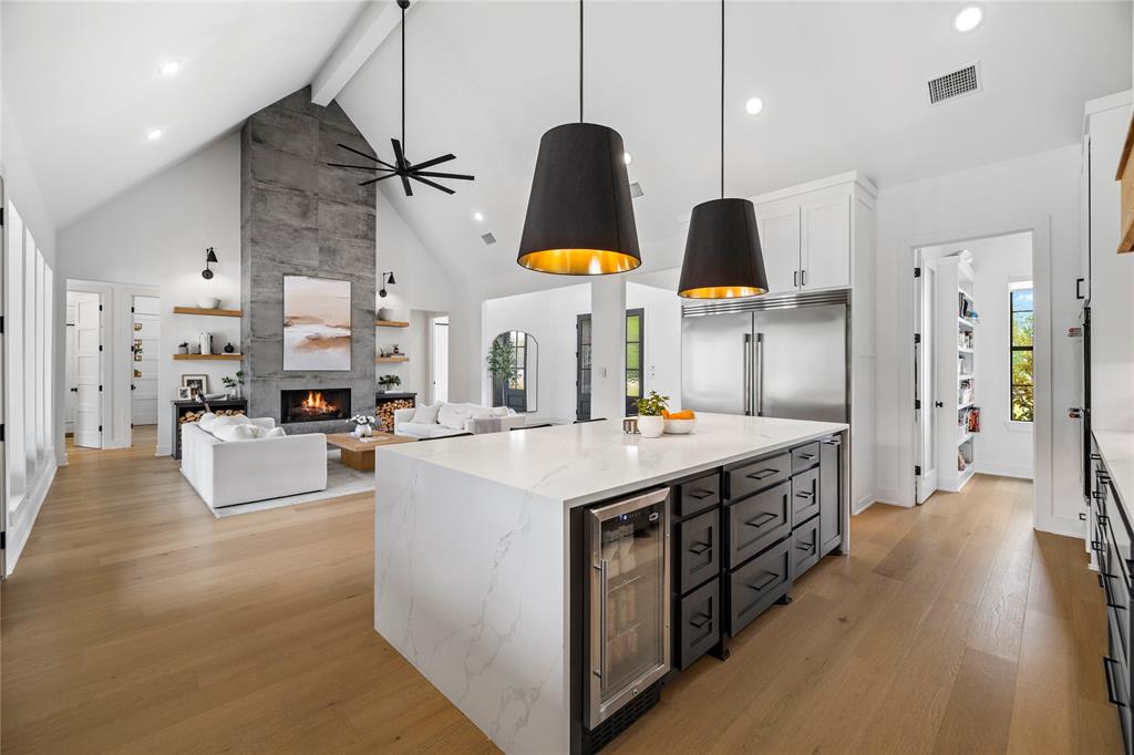 21197 Gatlinburg Road Bullard, TX 75757 - Photo 14 of 40 a large kitchen with stainless steel appliances kitchen island a large counter top a sink a stove and a refrigerator