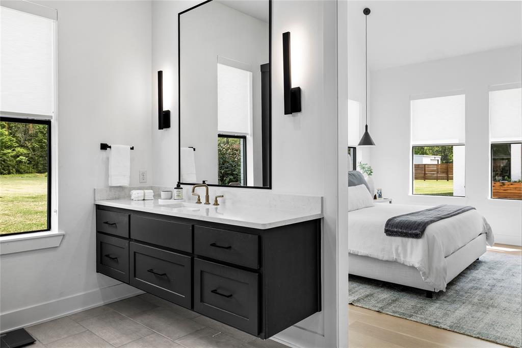 21197 Gatlinburg Road Bullard, TX 75757 - Photo 20 of 40 a spacious bathroom with a double vanity sink and a mirror