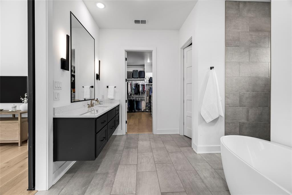 21197 Gatlinburg Road Bullard, TX 75757 - Photo 21 of 40 a spacious bathroom with a double vanity sink a mirror and a bathtub