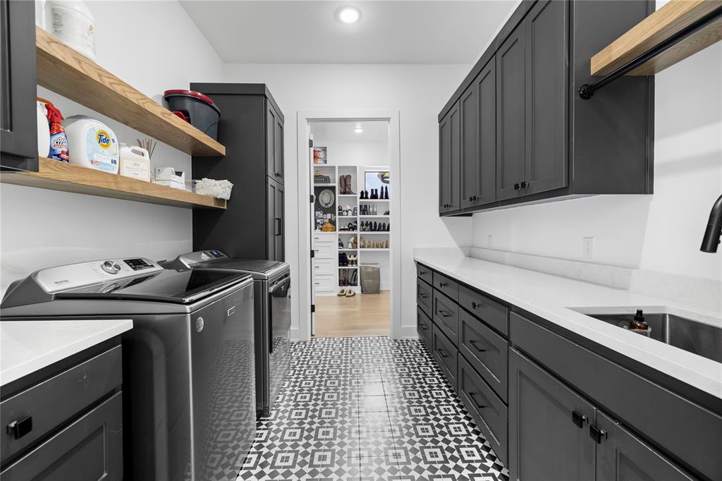 21197 Gatlinburg Road Bullard, TX 75757 - Photo 23 of 40 a kitchen with stainless steel appliances granite countertop a stove a sink and cabinets