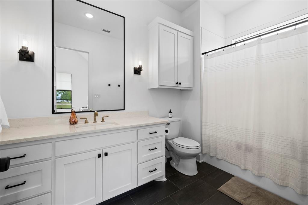 21197 Gatlinburg Road Bullard, TX 75757 - Photo 25 of 40 a bathroom with a double vanity sink and a toilet